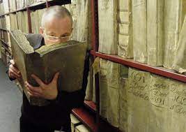 Man smelling a large old book