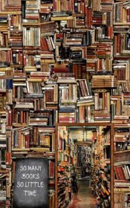 Messy Shelves of books with a sign saying so many books