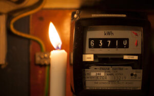 Candle by an electricity meter